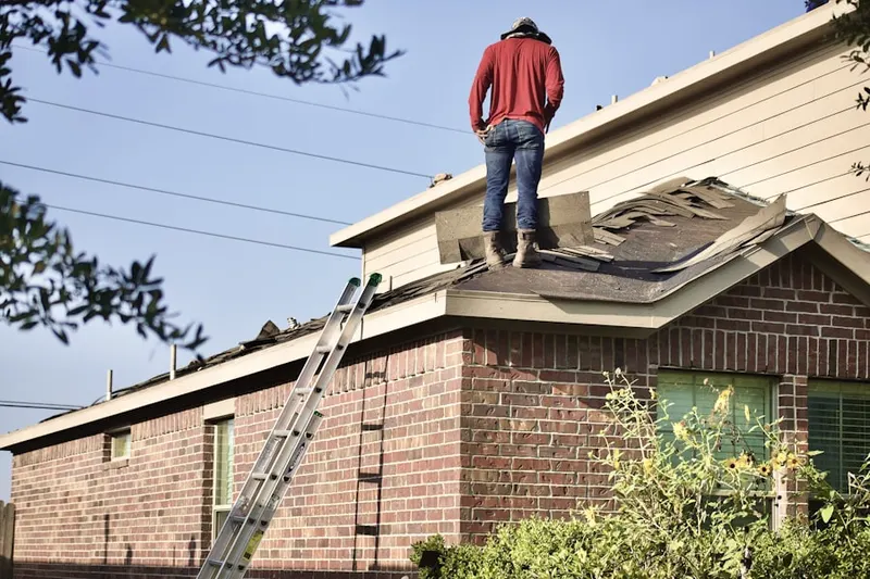 Professional roofer working on a residential roof in Airboro
